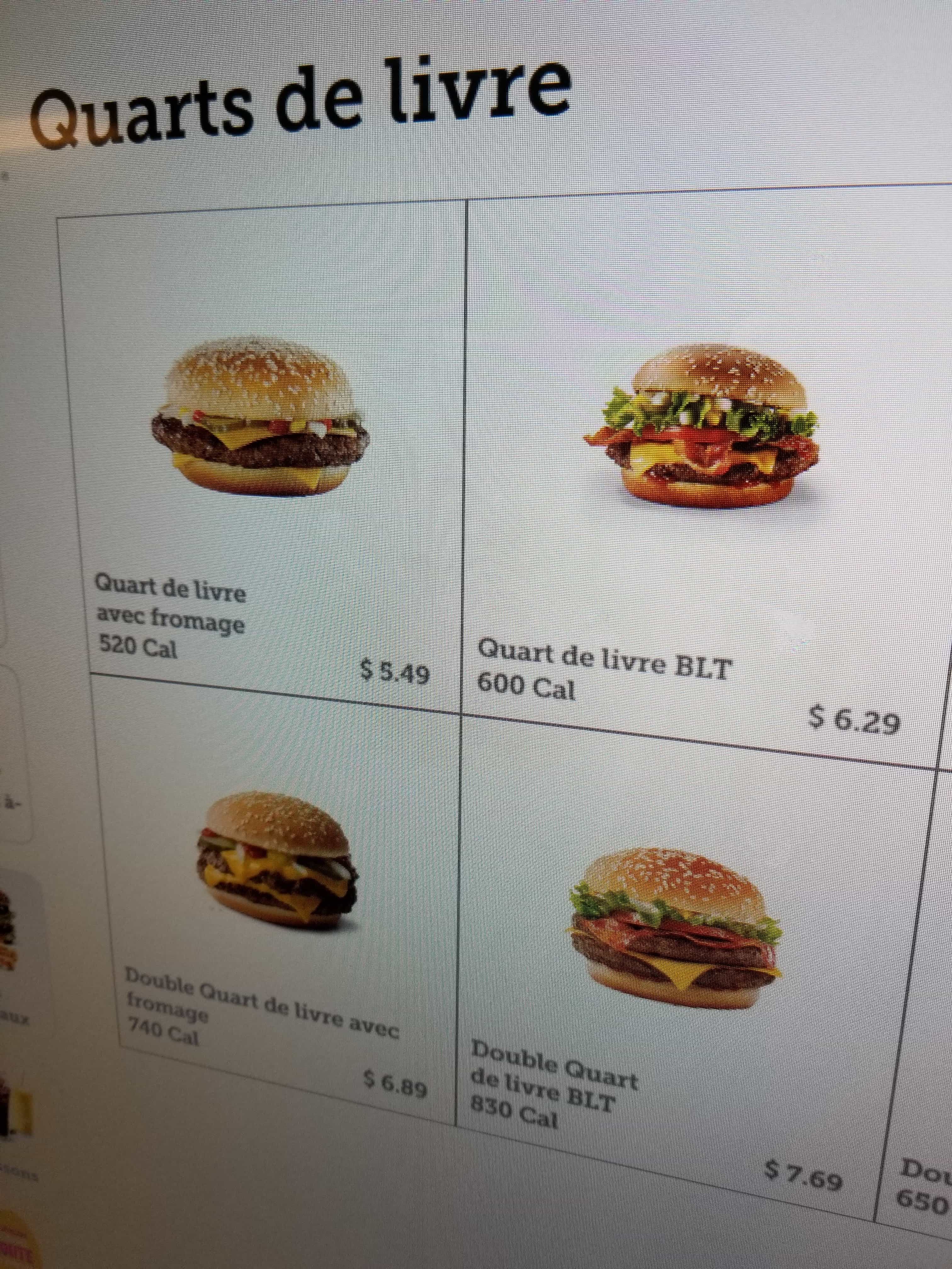 A picture of a menu with 4 hamburgers. Each one's name contains 'quart de livre'